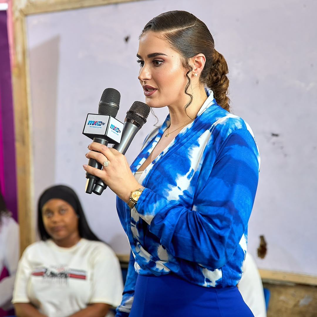 Shalimar Abbiusi speaking into a microphone at a community meeting