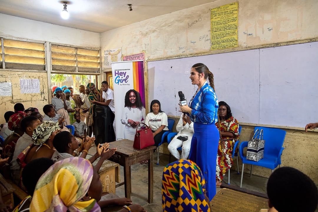A classroom filled with women attending a community meeting
