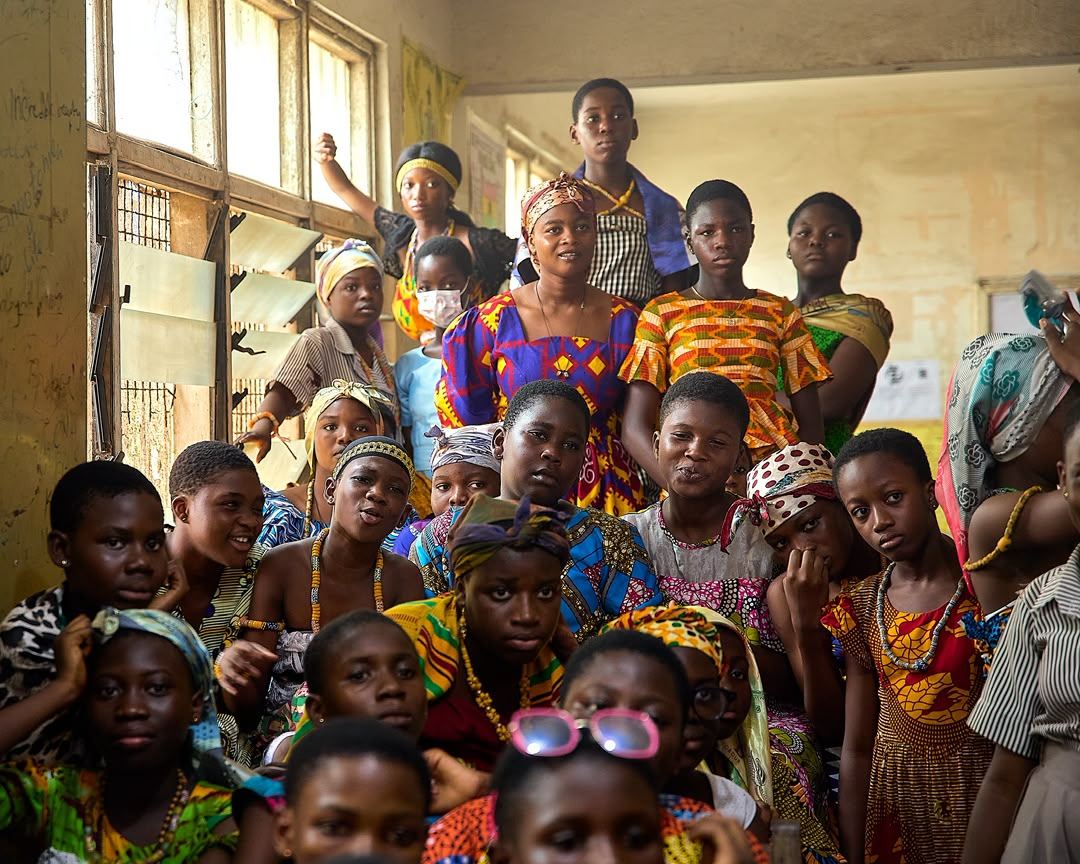 A crowd of women and children gathered in a doorway