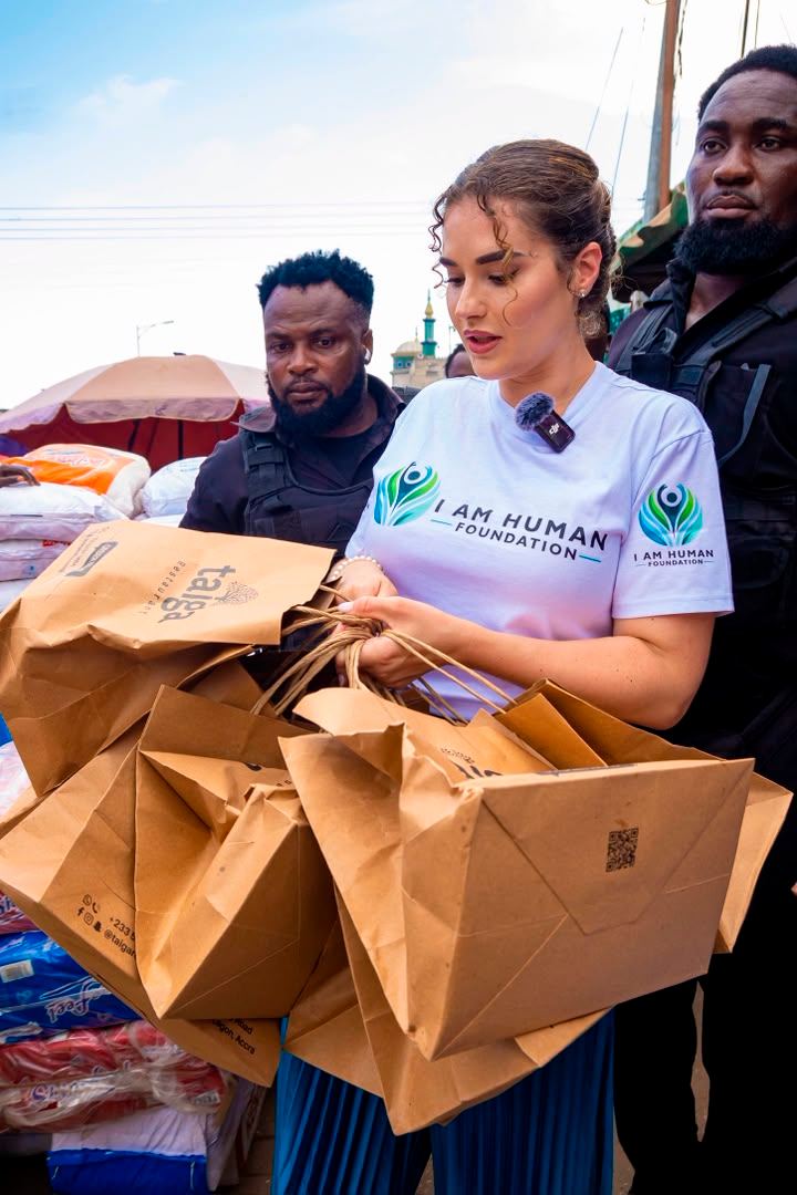 Shalimar Abbiusi carrying bags of supplies during a distribution