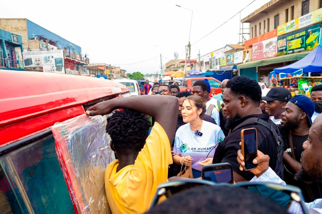 A distribution taking place from a vehicle on a busy street