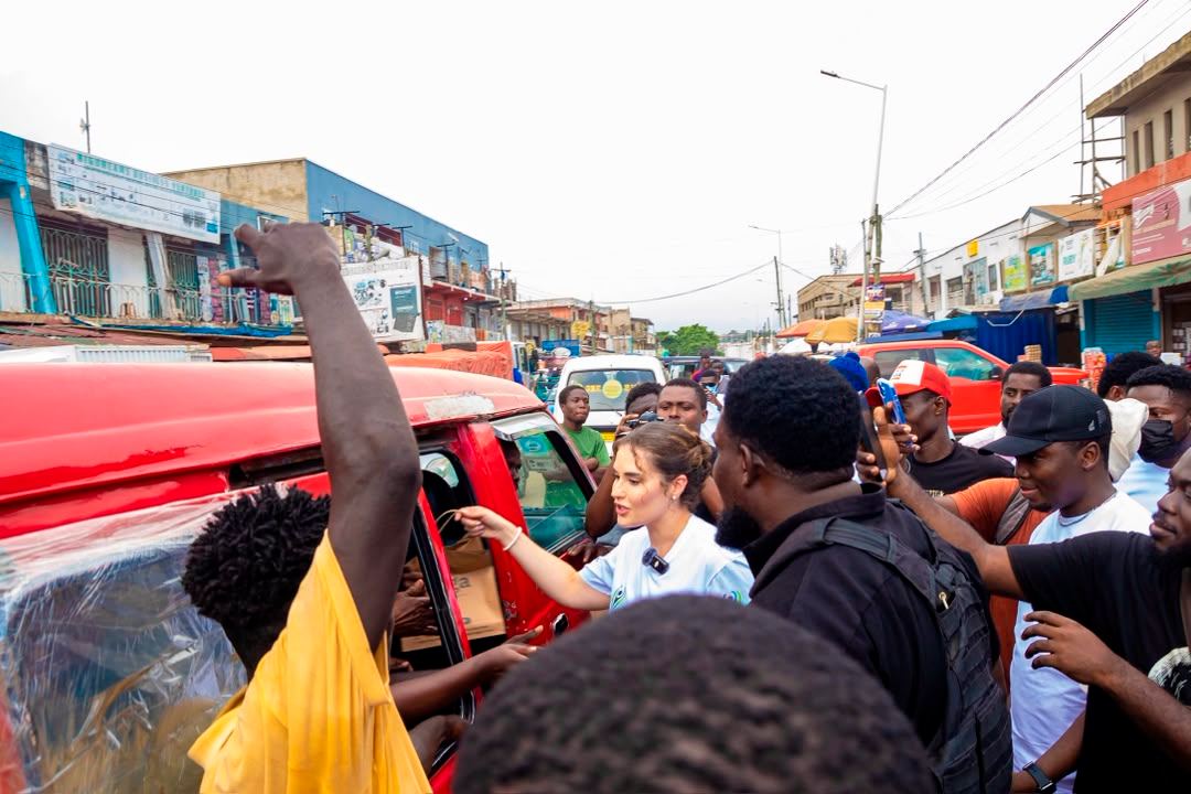 A crowd on a busy street during a community outreach