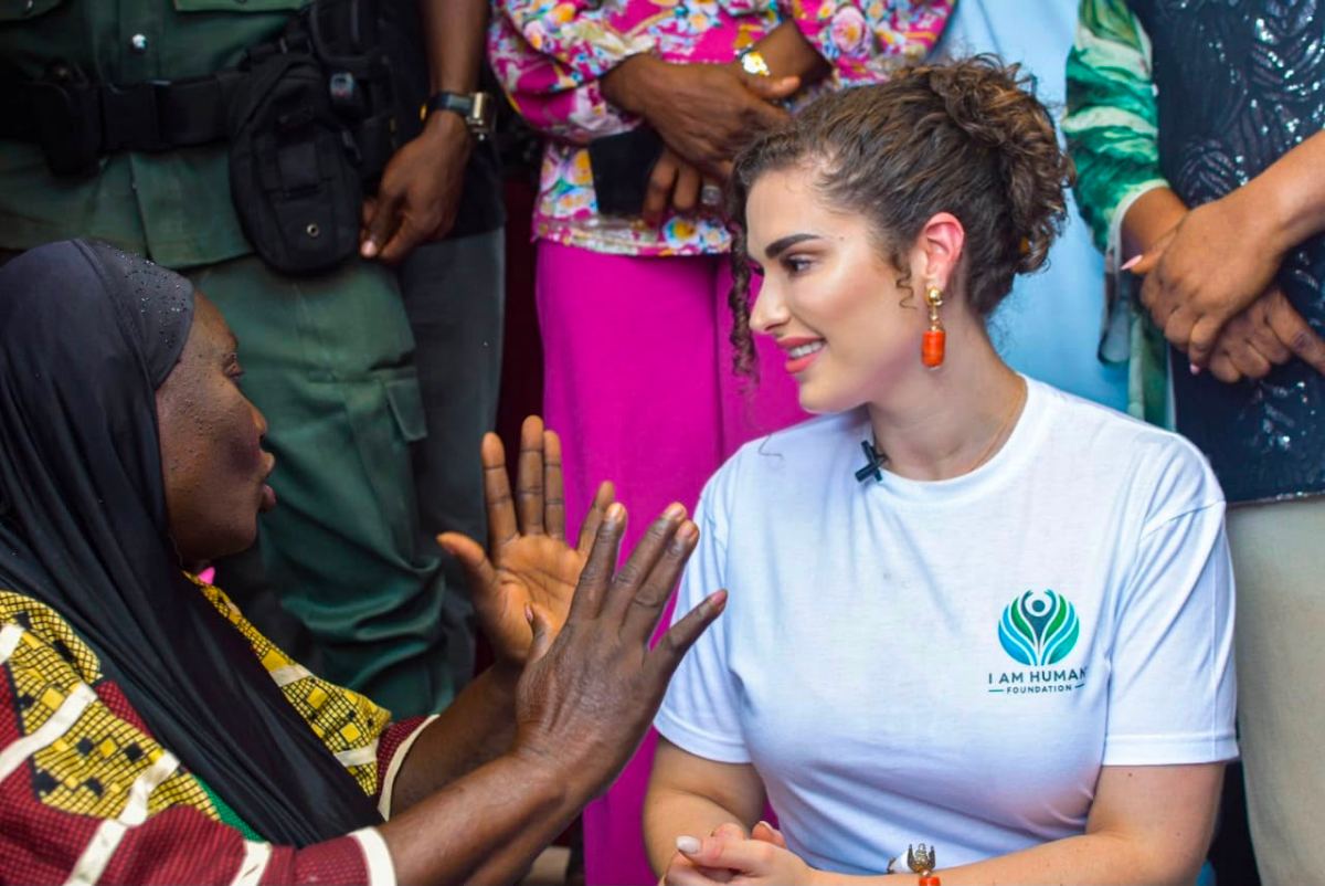 Shalimar Abbiusi greeting an elder, their hands clasped together