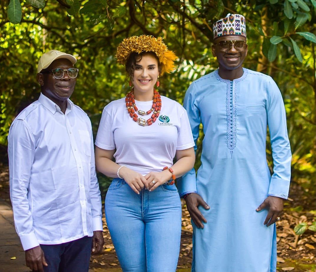 Shalimar Abbiusi standing outdoors with two community leaders
