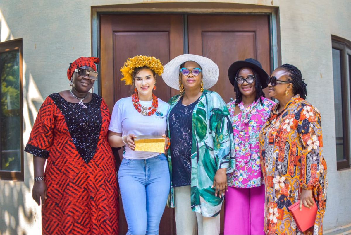 A group portrait with women outside a community building