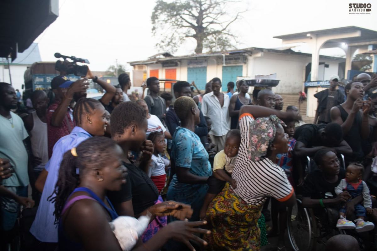 A street gathering during an outreach, including a person using a wheelchair